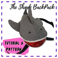 the shark back pack is designed to look like it has an apple in its mouth