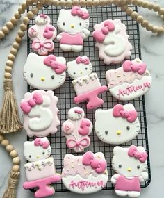 hello kitty cookies on a cooling rack with tassels