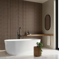 a large white bath tub sitting next to a wooden shelf in a bathroom under a mirror