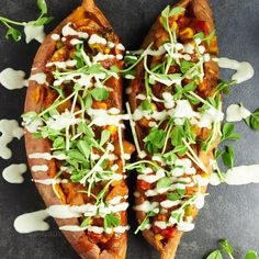 two pieces of pizza with toppings on them sitting on top of a black surface