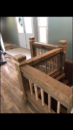 a wooden stair case in an empty room