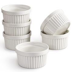 four white dishes stacked on top of each other