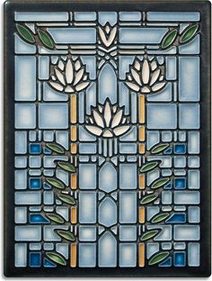 a stained glass window with flowers and leaves on it's side, in blue tones