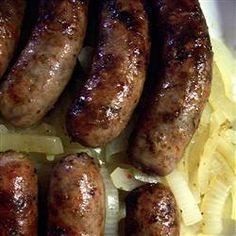 several sausages and onions on a plate