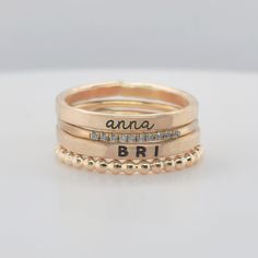 This stylish Layla Set features two 14K yellow gold filled name rings, a 10 mini cubic zirconia ring, and a beaded ring. As a layering set, two kids' rings make this the perfect everyday jewelry that offers subtle, yet memorable, sparkle. Includes one name in lowercase cursive and one name in uppercase bold. Please note that this set is handmade and can involve color variations due to soldering and engraving. We highly recommend ordering our ring sizer before purchase to ensure a good fit. Some Personalized Dainty Gold Engraved Ring, 14k Gold Stackable Rings With Custom Name For Anniversary, Custom Name Stackable Rings In 14k Gold For Anniversary, Custom Name 14k Gold Stackable Rings For Anniversary, Customizable 14k Gold Rings For Personalized Gifts, Customizable Adjustable Gold Engraved Ring, Personalized Stackable Gold Rings, Promise Ring With Nameplate Engraved, Personalized 14k Gold Engraved Ring For Mother's Day