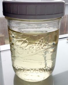 a jar filled with liquid sitting on top of a table