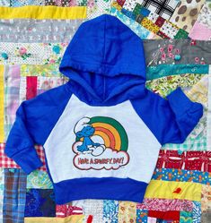 Adorable!! vintage 1980s Smurf Hoodie ~ Have A Smurfy Day!  Kids size 3/6M~ please rely on measurements for a perfect fit  In excellent vintage condition  No stains or holes!  Super nice!  Measurements taken with hoodie laid flat  10.5" armpit to armpit  10.5" long  Tag reads  6M  100% acrylic  Please look at measurements before purchasing to ensure a perfect fit.  Vintage clothing tag sizes sometimes differ from modern sizes.  I do my best to describe all stains and other imperfections as accur Minnie Mouse Sweatshirt, Strappy Shoes, Clothing Tags, Poly Mailers, Thrift Shopping, Packing Material, Etsy Australia, Vintage Clothing, Kids Hoodie