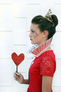 a woman holding a heart shaped lollipop in her hand with the caption, 100 + ideas about queen of hearts on pinterest