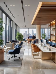 an office with large windows and lots of furniture in the middle of the floor to ceiling windows