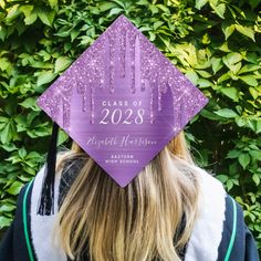 a purple graduation cap with the words class of 203 printed on it in front of some bushes