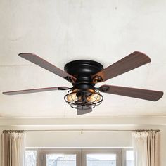 a ceiling fan with two light bulbs in a living room