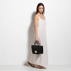 The Arcadia Trapeze combines geometric lines and an oversized front turn lock to create a contemporary style yet chic. A desing that stands out and matches perfectly with evening outfits. Evening Outfits, Geometric Lines, Contemporary Style, To Create, Turn Ons, Handbags