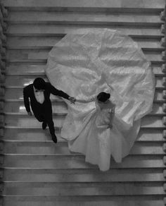 an aerial view of a bride and groom on the escalator