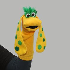 a person wearing a yellow and green stuffed animal