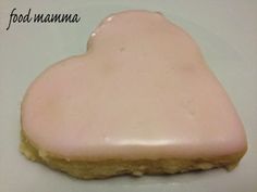 a heart shaped cookie sitting on top of a white plate