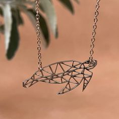 Our turtle origami necklace is carefully crafted for you or ideal as a gift. PRODUCT FAQs ◽ Turtle pendant dimensions: 37 mm wide x 17 mm high ◽ Necklace length: 45 cm + 5 cm extender ◽ Precision laser cut geometric animal pendant ◽ Material: alloy plated stainless steel ◽ Ultra durable for daily wear ◽ Registered design by Meraki Accents  ◽ Each necklace will arrive in an individual box, ready to be gifted SHIPPING FAQs ◽ Meraki Accents is based in England, UK ◽ We ship worldwide from England using Royal Mail postal service SPIRIT ANIMAL GUIDE ◽ Unlock your spirit animal and elevate your look with our origami animal necklaces. ◽ In many spiritual traditions and cultures, a spirit animal refers to an animal that guides a person on a journey and whose characteristics that person embodies. ◽ Handmade Geometric Jewelry Gift, Handmade Geometric Jewelry For Gifts, Adjustable Geometric Necklace For Gifts, Turtle Origami, Sea Turtle Jewelry, Origami Necklace, Animal Spirit Guides, Turtle Jewelry, Animal Necklace