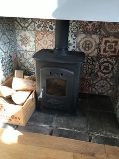 a wood burning stove in a room with patterned wallpaper on the walls and floor