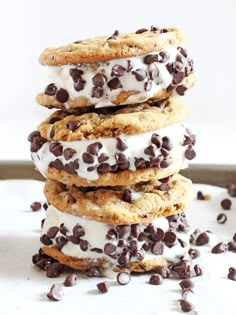 chocolate chip ice cream sandwich cookies stacked on top of each other with white icing and chocolate chips