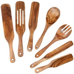 wooden utensils and spoons lined up on a white surface