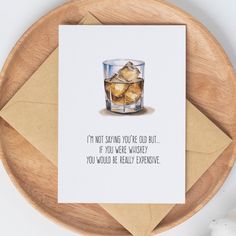 a card with an image of a glass of whiskey and ice cubes on it