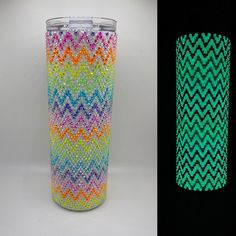 two different colored vases next to each other on a black background and one is made out of plastic beads