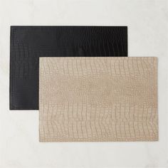 three different types of leathers laid out on a white surface with black and brown alligator skin