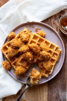 fried chicken and waffles on a plate with a fork