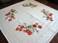 a white table cloth with strawberries on it