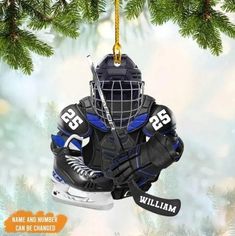 an ornament shaped like a hockey goalie's uniform and helmet hanging from a christmas tree