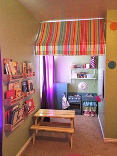 a child's playroom with colorful curtains and toys on the shelves in it