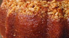 a bundt cake is sitting on a glass platter with some oatmeal toppings