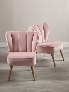 two pink chairs sitting next to each other on top of a gray carpeted floor