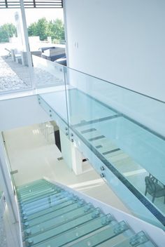 a glass staircase leading up to the second floor