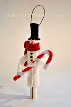 a snowman ornament hanging from a string