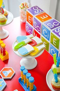 a red table topped with cupcakes and toys