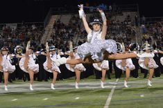 a group of cheerleaders perform on the field