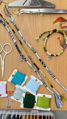 sewing supplies are arranged on a table with scissors, thread and other crafting items