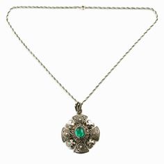 "This ornate Jerusalem Cross pendant is composed of pure silver and features a green cabochon at the center. The pendant has a layered construction with a solid platform topped by convex decorative elements. The surface of the pendant is highly detailed with extensive granulation and wire work and has 4 crosses with brightly polished surfaces at each corner. The pendant comes with its original fan-shaped bail which also bears ornamental granulation and wirework. The back of the bail is fitted wi Silver Emerald Necklace With Intricate Design, Ornate Silver Oval Cabochon Jewelry, Victorian Green Medallion Jewelry, Traditional Oval Emerald Jewelry, Ornate Green Oval Necklaces, Ornate Oval Jewelry With Large Pendant, Silver Emerald Necklace With Intricate Design As Gift, Silver Emerald Jewelry With Oval Cabochon, Crusader Cross