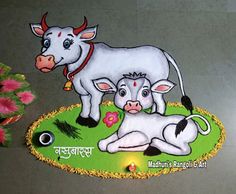 a cow and calf sitting on top of a green rug