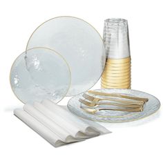 a table setting with plates, napkins and gold - plated utensils