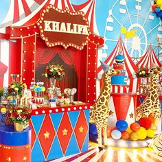 a circus themed birthday party with giraffes and balloons