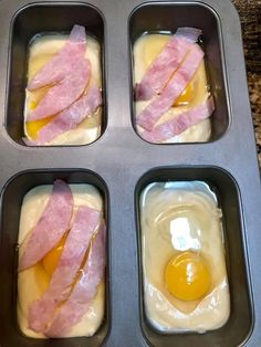 four muffin tins with eggs and bacon in them