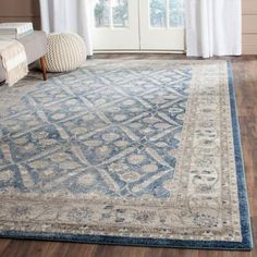 a blue and beige area rug in a living room