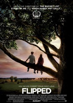 a movie poster with two people sitting on a tree and the words flipped in front of them