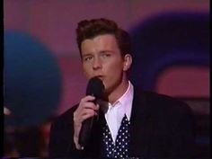 a man in a suit and tie holding a microphone