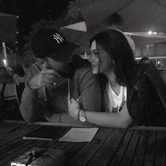 black and white photograph of two people sitting at a table