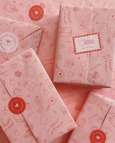 several pink envelopes with red and white designs on them are scattered around each other