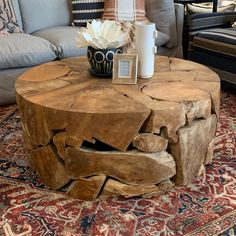 a coffee table made out of logs on top of a rug