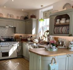 a kitchen filled with lots of appliances and counter top next to a wooden floor covered in dishes