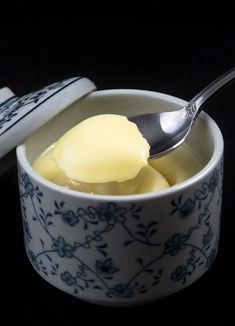 a spoon with butter in it is next to a bowl